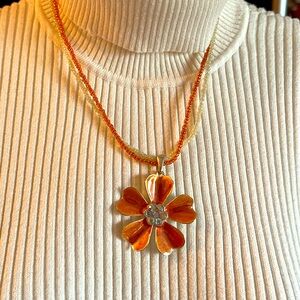 Cute double-strand,orange flower necklace with matching earrings.Clasp closure.